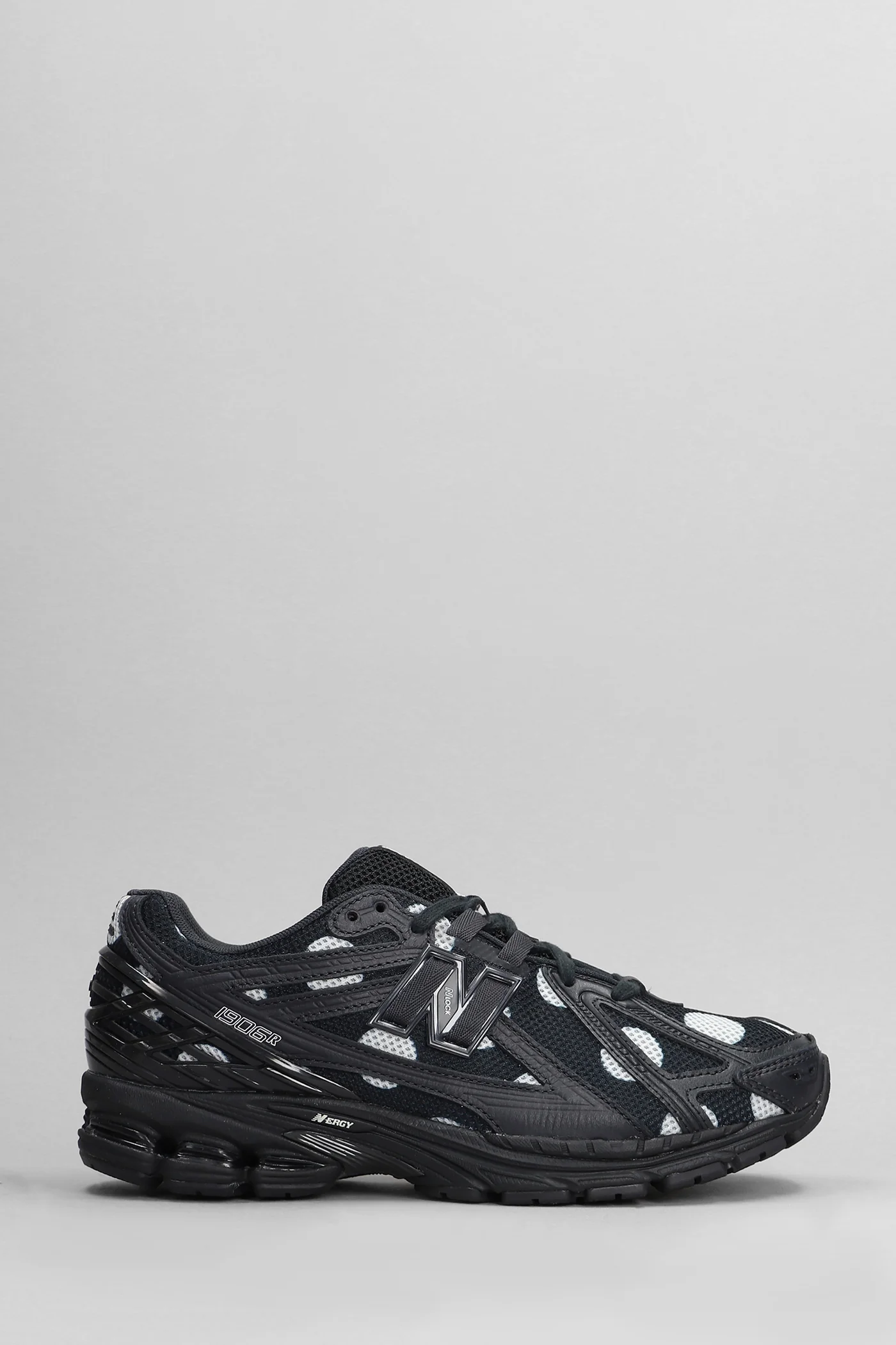 1906R Sneakers in black leather and fabric